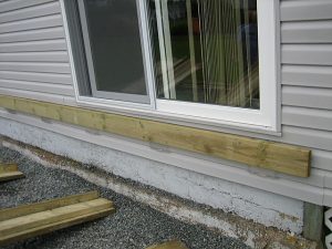 Siding saver mounting brackets attached to deck ledger board.