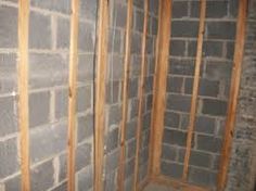 Attaching furring strips to concrete basement walls.