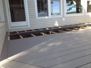 Composite decking boards being installed on this deck.