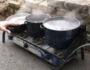 Boiling maple sap to produce maple syrup.