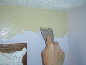 Scraping off old wallpaper border.